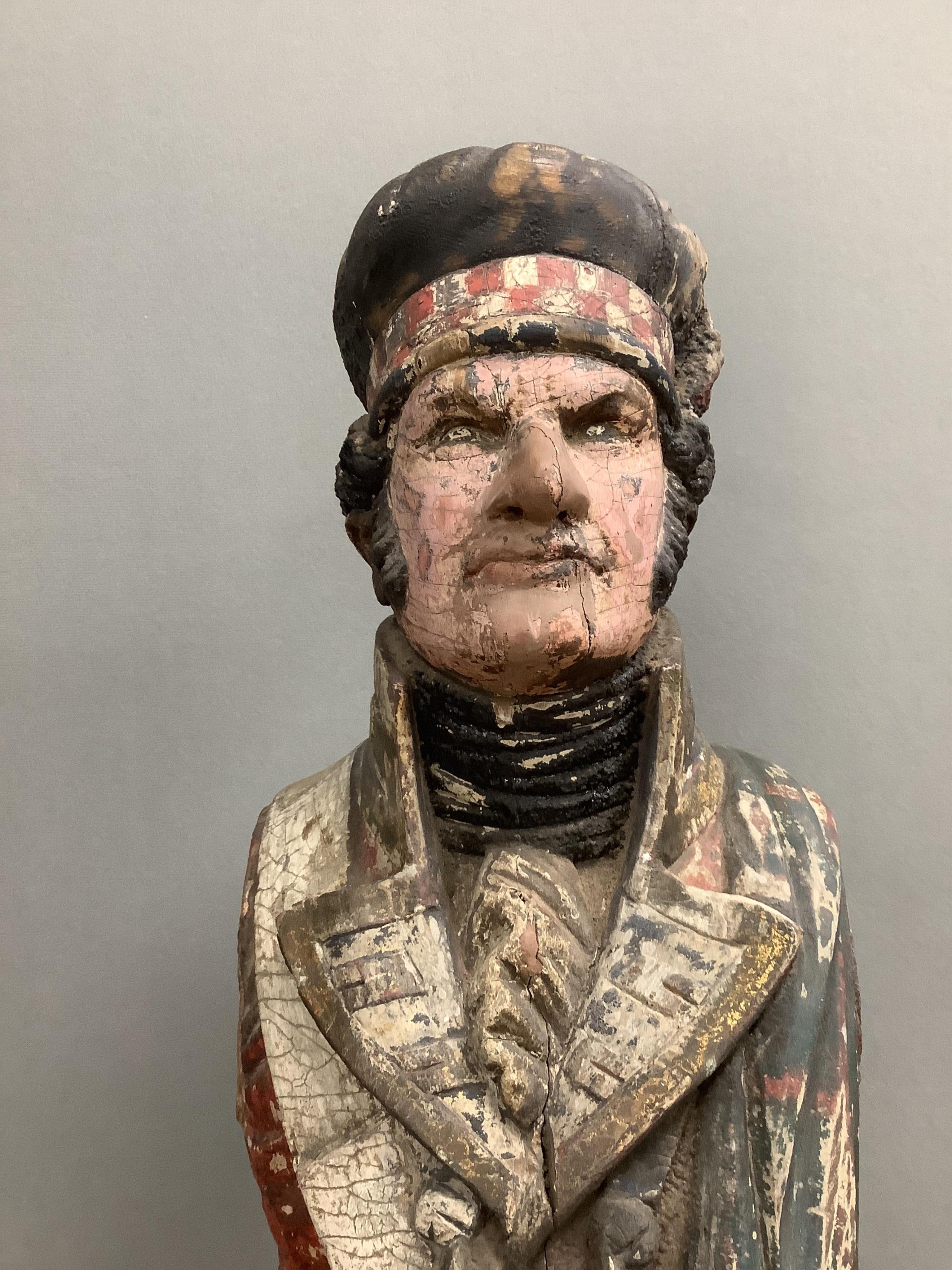 A large 19th century carved and painted Highlander ‘Snuff’ shop advertising figure. 109cm high. Condition - paint work and base weathered, arms detached.